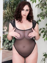 Plump brunette model Milly Marks releases her knockers from see thru onesie